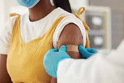Buy stock photo Vaccine, covid and a plaster on the arm of a black woman in a hospital for healthcare. Nurse, doctor and medical with a medicine professional in a clinic to apply a bandaid after corona vaccination