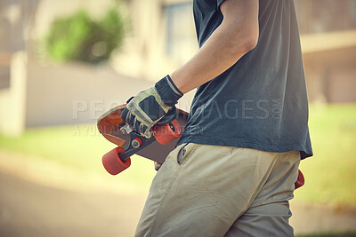 Buy stock photo Fun, skateboard and man skateboarding in a neighborhood for fitness, exercise and training. Sport, cardio and hands of a teenager with a board in the street to travel, commute and playing in the road