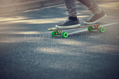 Street, urban sports and feet on skateboard for teenage fun, alternative transport or fitness in city. Road, sneakers and free skateboarder riding board in park with balance and eco friendly travel.
