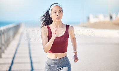 Buy stock photo Woman running at beach promenade for fitness, energy and strong summer body. Female runner, sports person and athlete at seaside for marathon, cardio exercise and healthy wellness workout in sunshine