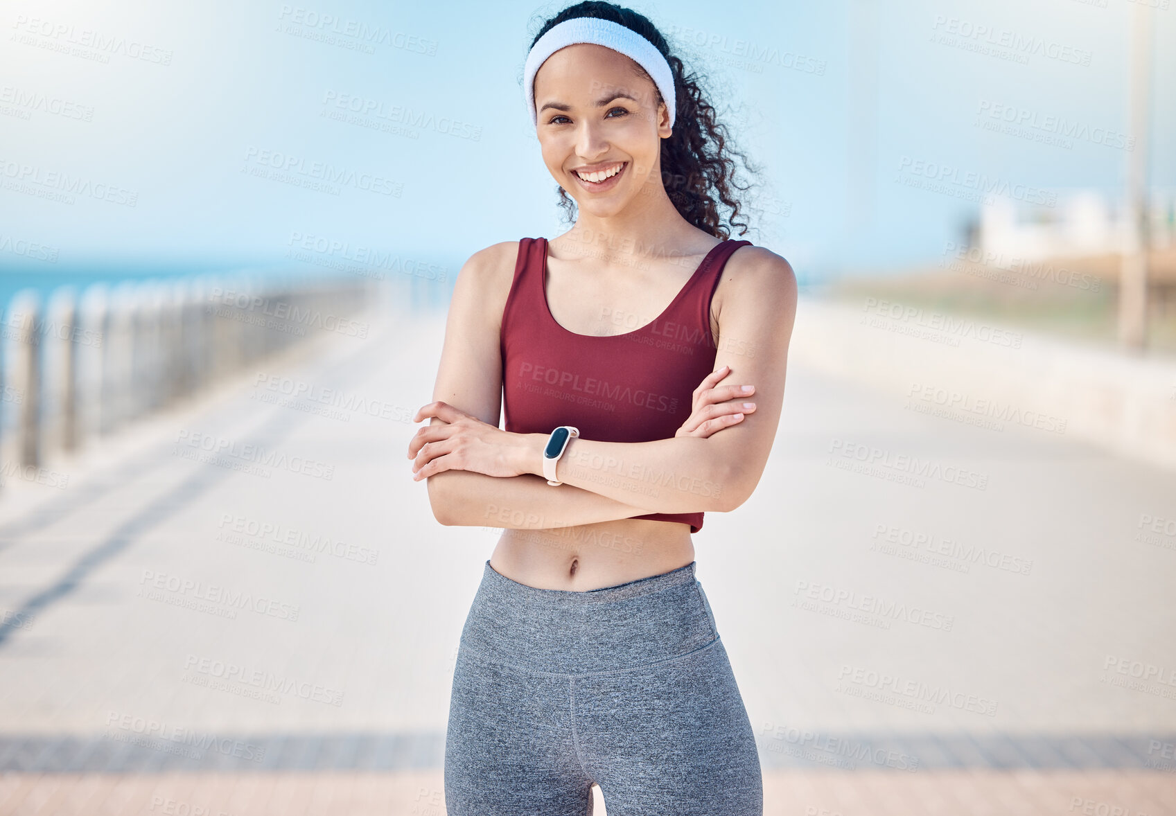 Buy stock photo Happy woman, portrait and fitness with arms crossed at beach promenade for exercise, wellness and health in Miami. Female athlete, smile and standing at seaside for workout, summer training or sports