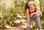 Tired, time and woman running in nature for fitness, training motivation and check steps in Argentina. Sports, health and athlete runner with a watch for a forest workout, cardio and exercise fatigue