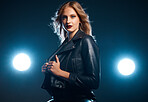 Portrait, fashion and lights with a model woman in studio on a dark background wearing a leather jacket for style. Art, spotlight and trendy with an attractive young female posing on black space