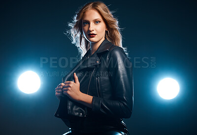 Buy stock photo Portrait, fashion and lights with a model woman in studio on a dark background wearing a leather jacket for style. Art, spotlight and trendy with an attractive young female posing on black space