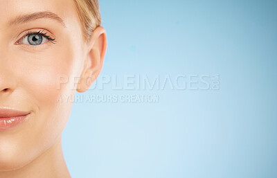 Buy stock photo Skincare, smile and half portrait of a woman for dermatology isolated on a blue background. Makeup, wellness and face of a model for cosmetics, health and collagen with mockup space on a backdrop