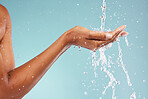 Sustainability, ecology and hand of a woman with water isolated on blue background in a studio. Environment, clean energy and person with a splash to recycle liquid for agriculture change on backdrop