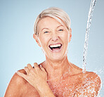Happy, cleaning and portrait of a woman with a water splash isolated on a blue background in studio. Grooming, hygiene and face of an excited senior model with body and self care on a backdrop