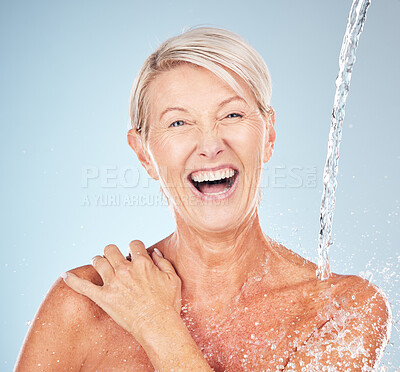 Buy stock photo Happy, cleaning and portrait of a woman with a water splash isolated on a blue background in studio. Grooming, hygiene and face of an excited senior model with body and self care on a backdrop