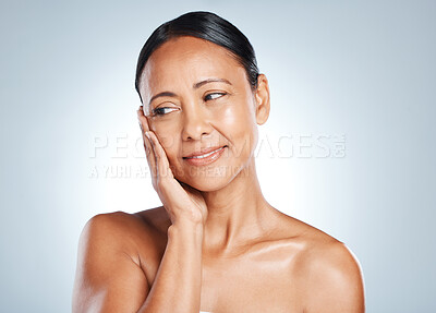Buy stock photo Face, skincare and thinking with a model black woman in studio on a gray background for antiaging beauty. Skin, idea and facial with an attractive mature female touching her cheek for wellness