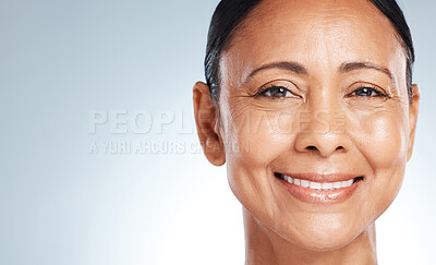 Buy stock photo Mockup, skincare and portrait of a senior woman with beauty isolated on a blue background in studio. Anti aging, health and face of an elderly model happy about facial dermatology on a backdrop