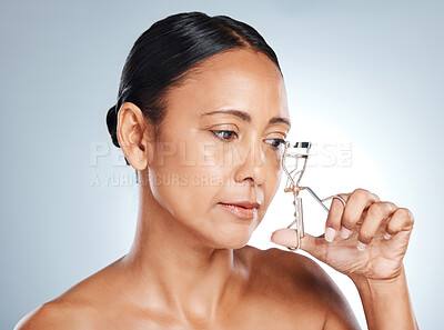 Buy stock photo Face, beauty and woman with eyelash curler in studio isolated on a gray background. Cosmetics, makeup and mature and beautiful female model holding tool or product to curl eyelashes for aesthetics.
