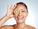 Beauty, kiwi product and portrait of woman with smile on face for vitamin c facial detox and happy on studio background. Healthy skincare, wellness and sustainability in fruit, luxury cleaning on eye