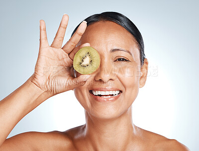 Buy stock photo Beauty, kiwi product and portrait of woman with smile on face for vitamin c facial detox and happy on studio background. Healthy skincare, wellness and sustainability in fruit, luxury cleaning on eye