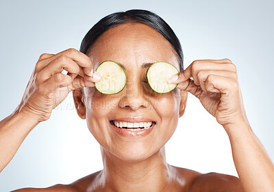 Buy stock photo Cucumber, woman face and natural skincare, beauty or clean wellness on studio background. Happy model, eyes and green fruits cosmetics, detox and facial nutrition with vitamin c for healthy aesthetic