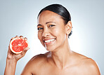 Grapefruit, happy woman and face portrait for beauty on studio background. Skincare model, smile and citrus fruits for natural cosmetics, detox and nutrition benefits for healthy aesthetic results 