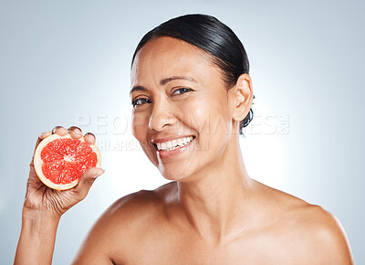 Buy stock photo Grapefruit, happy woman and face portrait for beauty on studio background. Skincare model, smile and citrus fruits for natural cosmetics, detox and nutrition benefits for healthy aesthetic results 