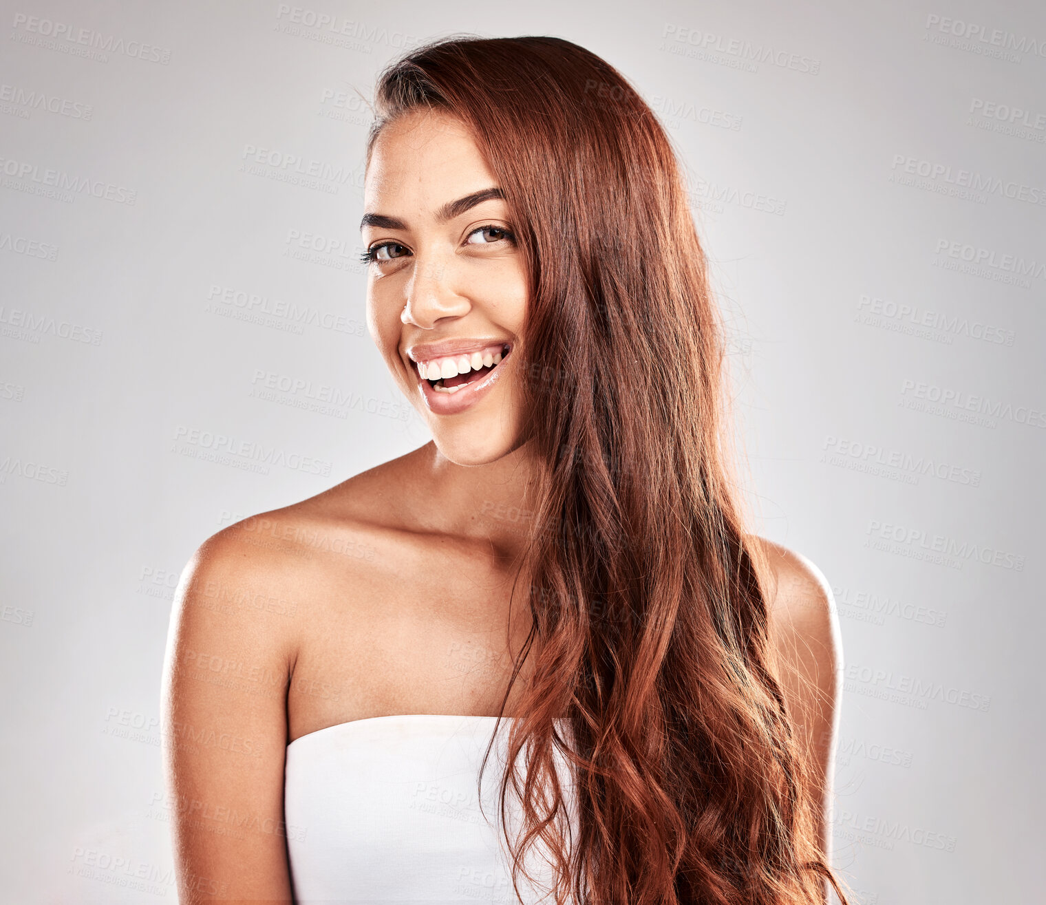 Buy stock photo Hair care, beauty and portrait of a woman in studio for a keratin, brazilian or botox hair treatment. Happy, smile and female model with a wavy, long and shiny hair style isolated by gray background.