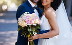 Flowers, wedding and marriage with a bride and groom posing outdoor for a photograph at their celebration event or ceremony. Rose bouquet, love and romance with a newlywed black couple outside