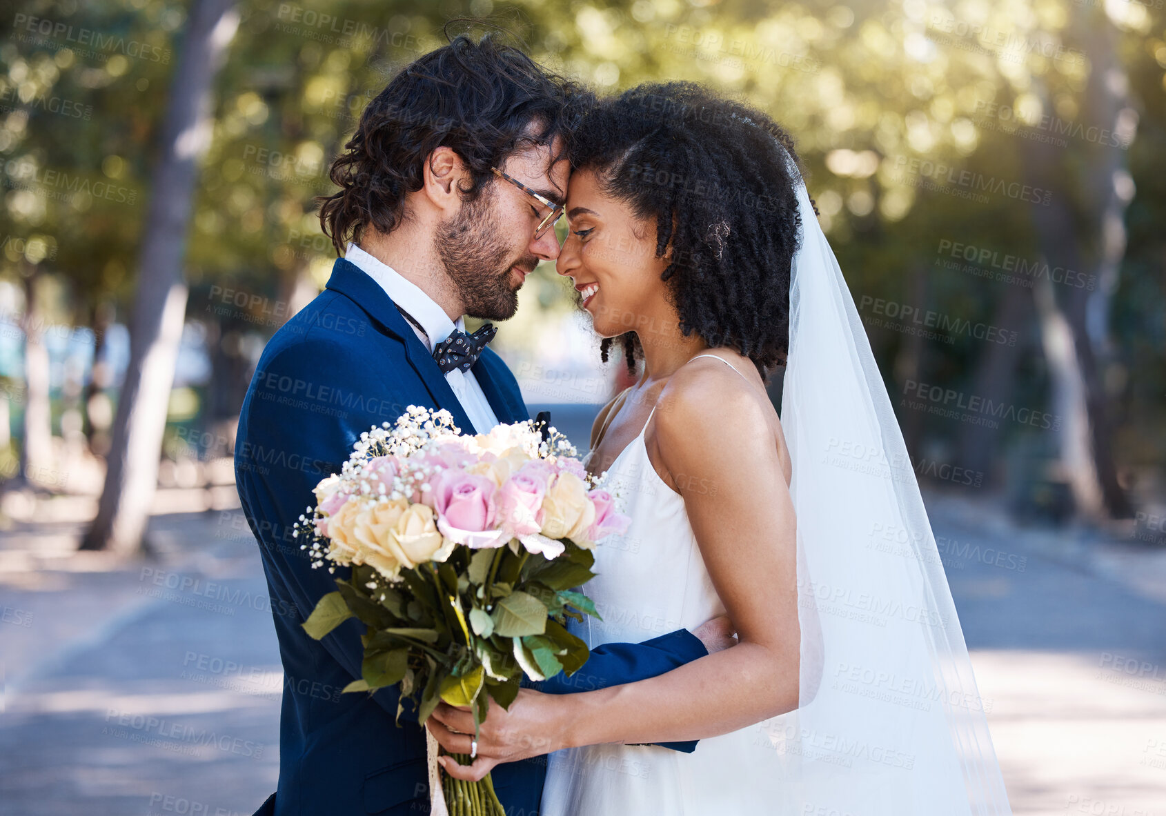 Buy stock photo Married couple, flower bokeh and smile for commitment, marriage or love together in the park. Happy groom and bride smiling in happiness for honeymoon, romance and embracing relationship in nature