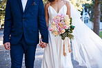 Bouquet, wedding and love of bride, groom and outdoor photograph at celebration, event or reception. Roses, flowers and marriage of bridal couple, romance and park in commitment, union or partnership
