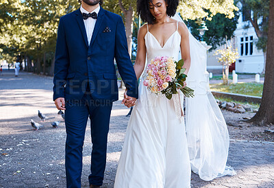 Buy stock photo Love, wedding and couple with flowers holding hands outdoors at park together. Marriage, diversity or affection, care or romance of man, woman or bride and groom walking with bouquet of roses.