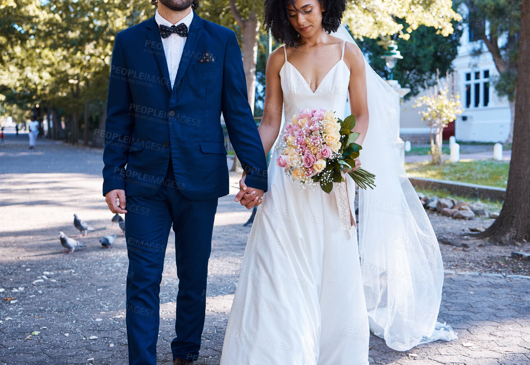 Buy stock photo Love, wedding and couple with flowers holding hands outdoors at park together. Marriage, diversity or affection, care or romance of man, woman or bride and groom walking with bouquet of roses.