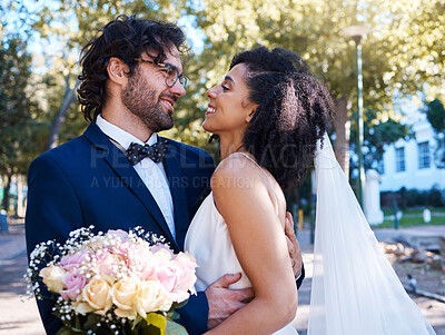 Buy stock photo Interracial love and couple wedding with flowers for romantic outdoor marriage event celebration together. Partnership, commitment and trust embrace of happy bride and groom with excited smile.