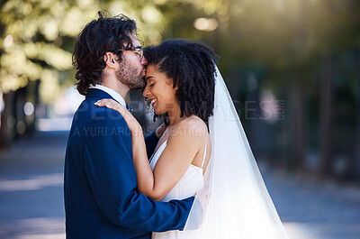 Buy stock photo Wedding, happy and kiss of couple with hug at romantic outdoor marriage event celebration together. Partnership, commitment and trust embrace of interracial bride and groom with excited smile.