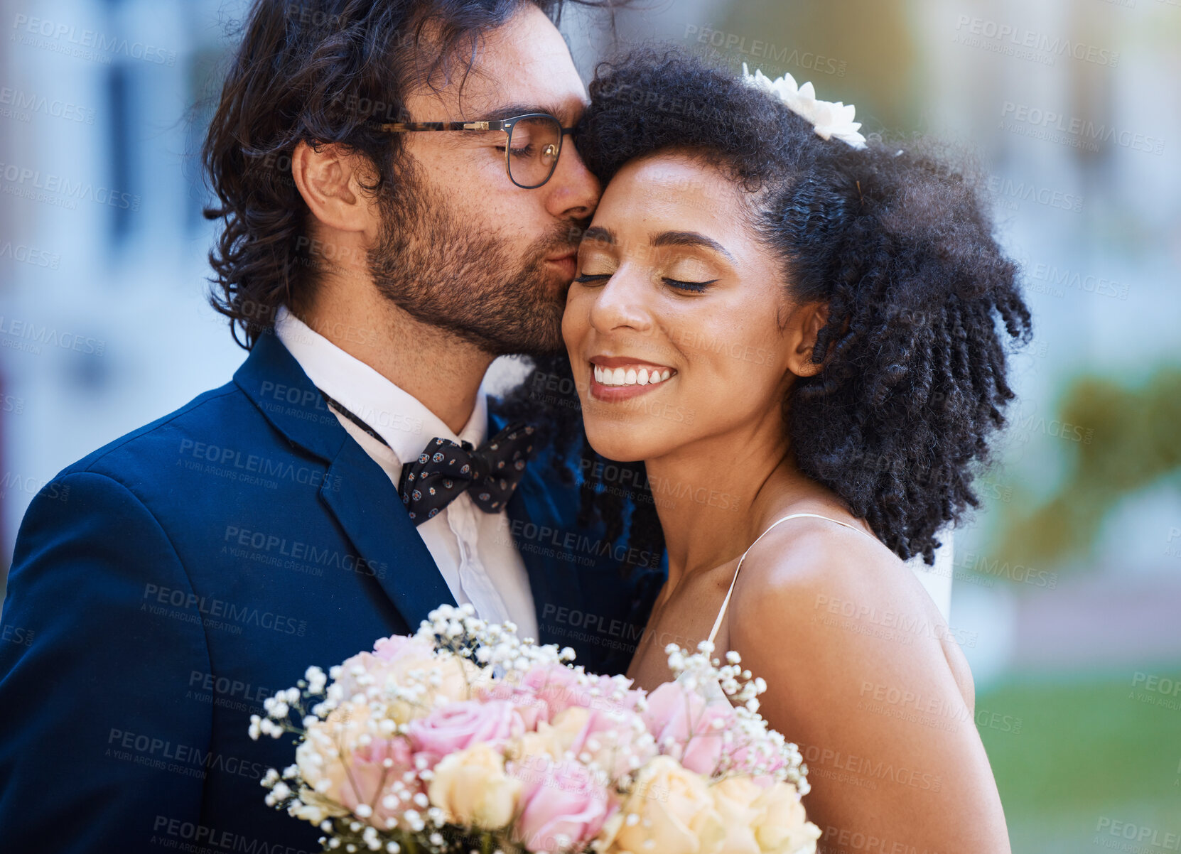 Buy stock photo Care, kiss and couple at wedding happy with romantic outdoor marriage event celebration with flowers. Partnership, commitment and trust embrace of interracial bride and groom with excited smile.
