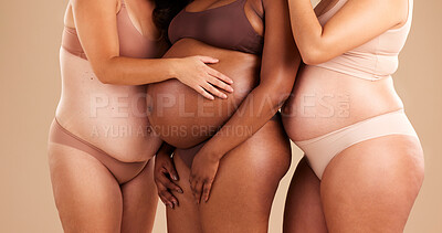 Buy stock photo Pregnant women, diversity or stomach on studio background in body love, baby or community support. Pregnancy hands, tummy or family planning for people, models or mothers in underwear or future life