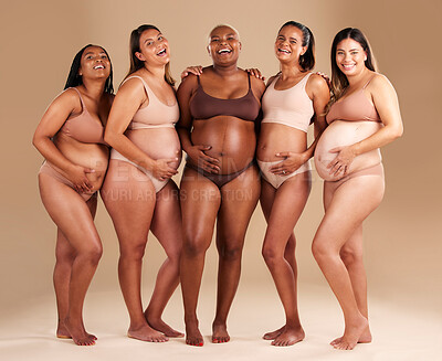 Buy stock photo Pregnancy, body and portrait of happy friends in a studio for diversity, motherhood and prenatal wellness. Maternity, beauty and pregnant women showing baby bump stomach together by beige background.