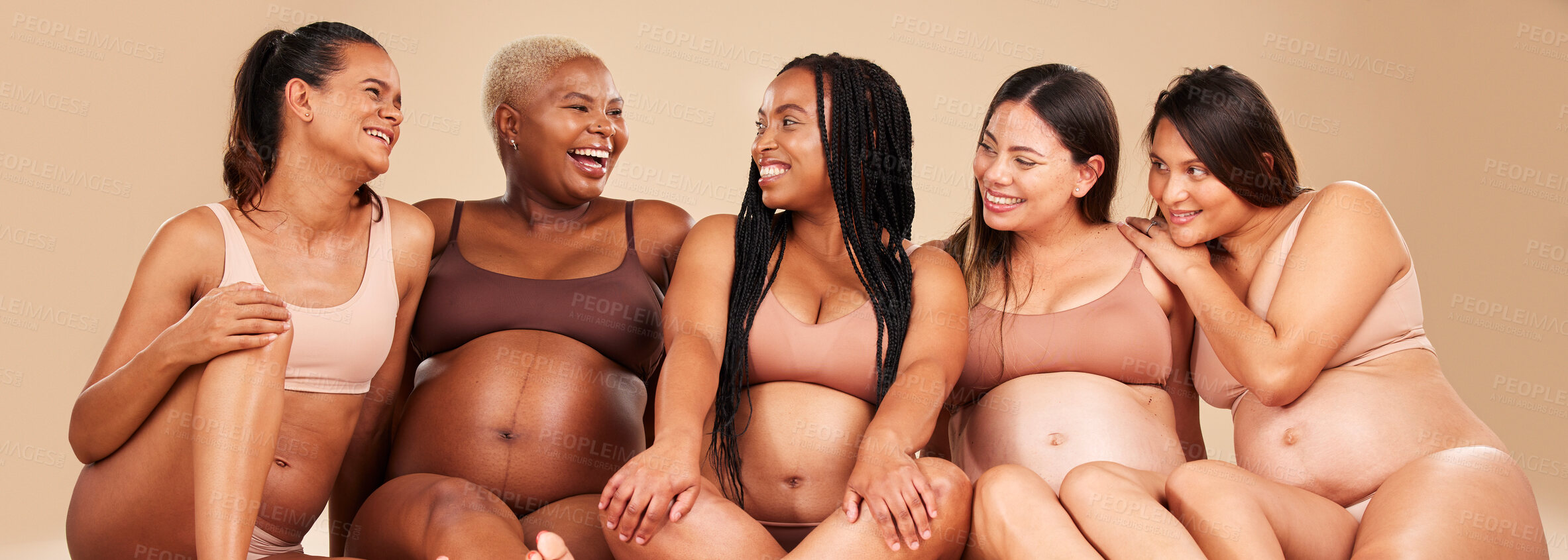 Buy stock photo Laughing, bonding and pregnant women sitting on floor in community, diversity support or body wellness. Smile, happy and pregnancy friends in underwear with funny, comedy or comic joke for healthcare