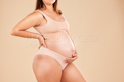 Buy stock photo Woman, body or holding pregnancy stomach in underwear on studio background protection, love or baby support. Person, pregnant or touching belly in growth check, future planning or healthcare wellness