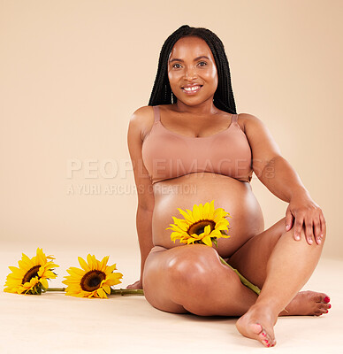 Buy stock photo Black woman sitting with flower, pregnant with smile in portrait and beauty, skincare isolated on studio background. Pregnancy glow, mother and nature with natural cosmetic care, health and wellness