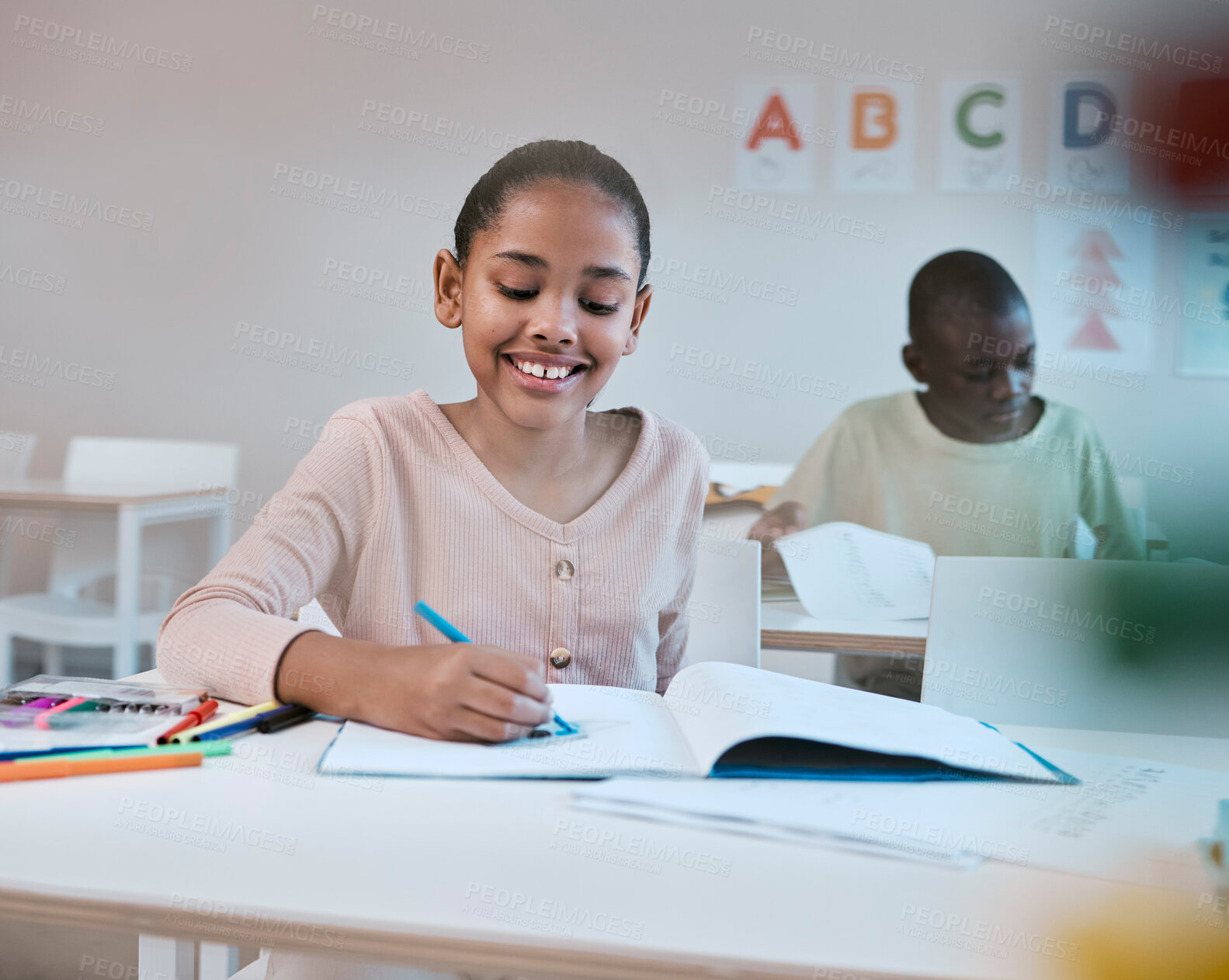 Buy stock photo Education, smile and child in classroom learning reading, writing and math in Montessori school in New York. Books, students and happy girl at kid desk in class with notebook studying for future exam