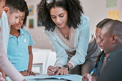 Buy stock photo African teacher teaching children, helping students in classroom with homework and writing in book. Diversity in education, educator reading kids notebook and group learning together for assessment