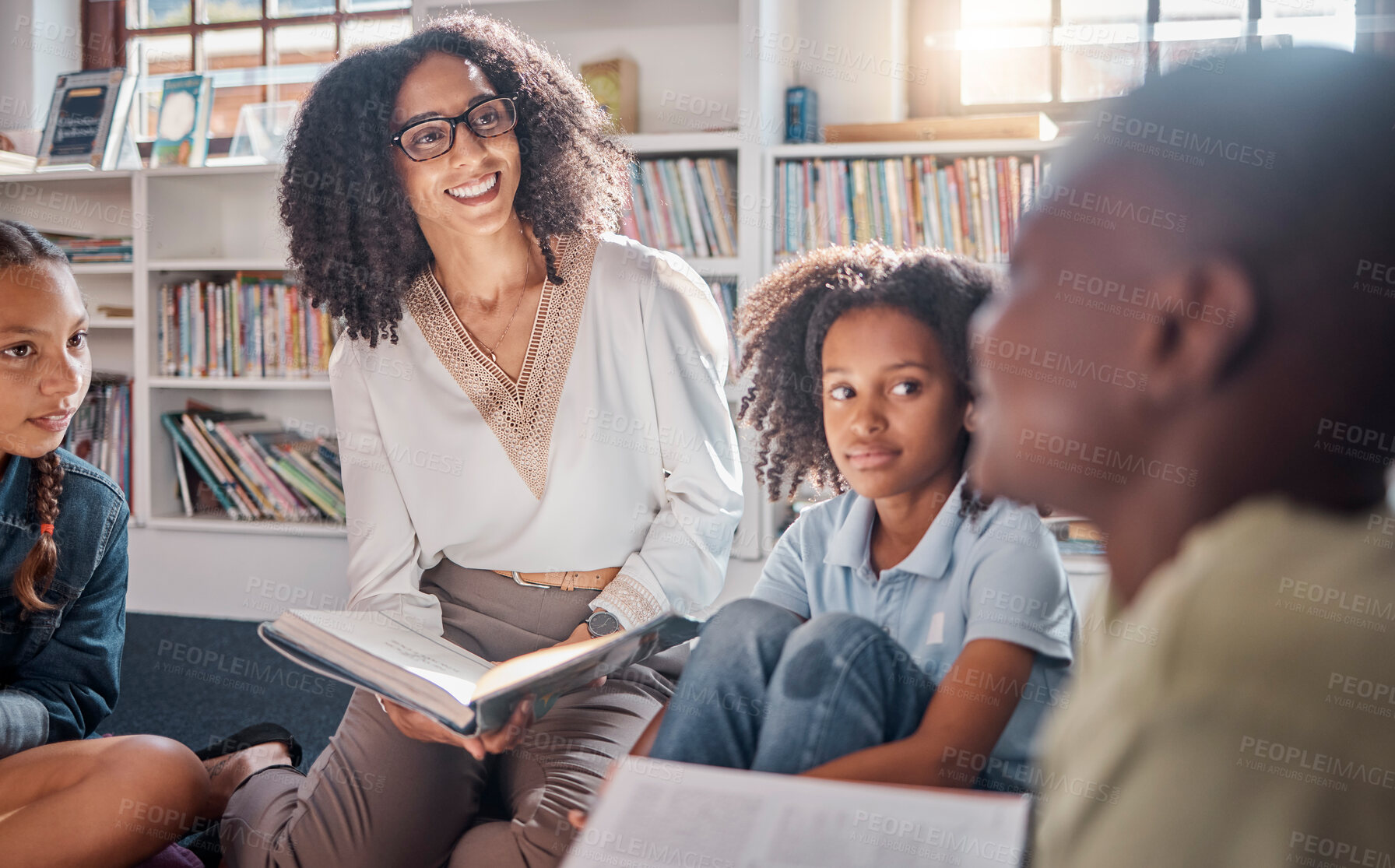 Buy stock photo Storytelling, teacher or students with talking in a library asking questions for learning development. Education, kids or children listening to a black woman speaking on fun books at school classroom