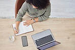 Laptop, writing and notebook with a business black woman at work on a schedule in her office from above. Computer, research and overhead with a female employee planning while working at a desk