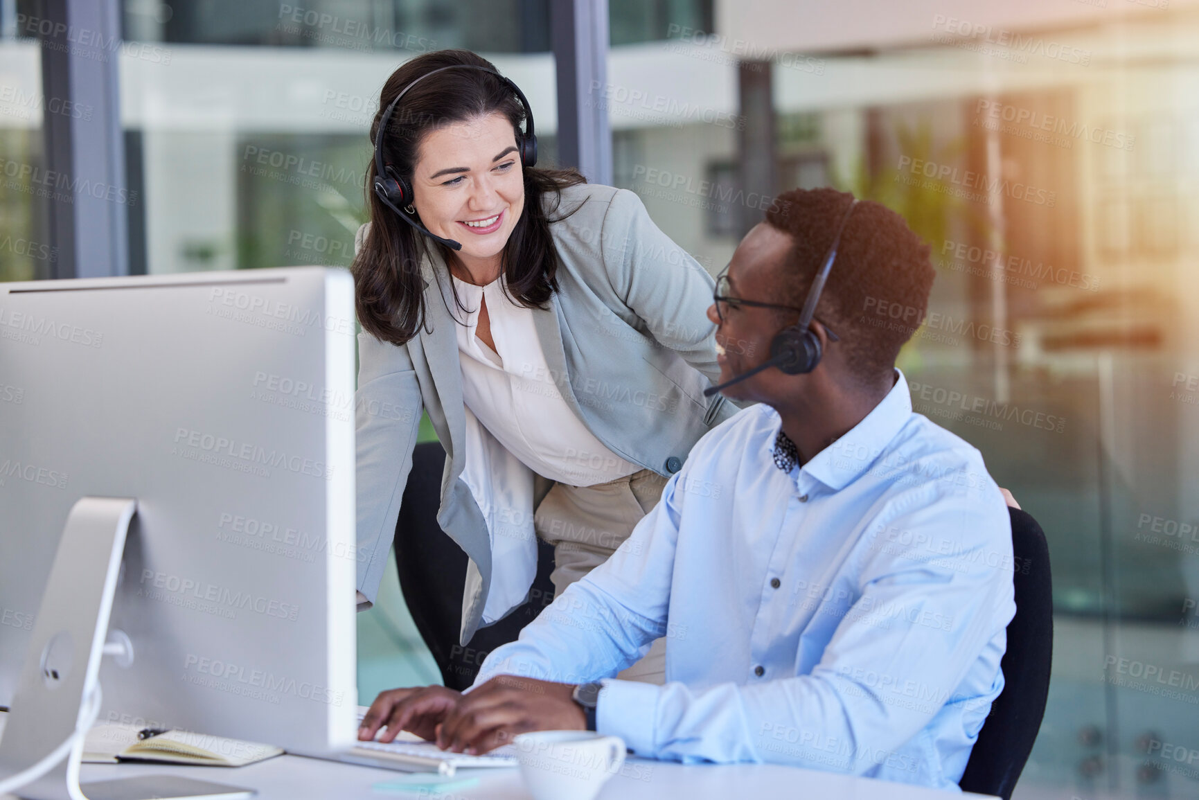 Buy stock photo Call center, customer service and a manager talking to a black man consultant in their telemarketing office. Ecommerce, contact us and training with a female supervisor coaching a male sales employee