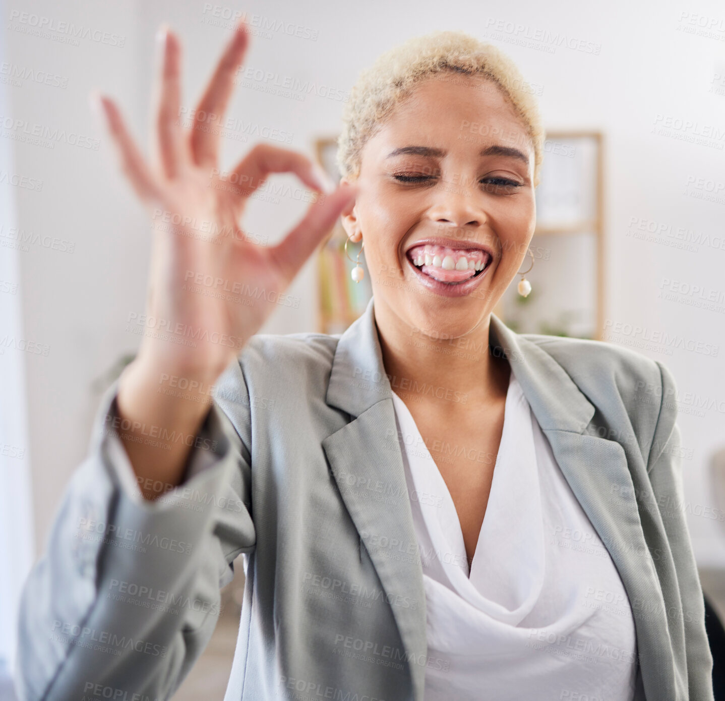 Buy stock photo Portrait, tongue and emoji with a business black woman winking in her office at work to gesture a perfect hand sign. Face, motivation and succes with a female employee feeling happy or proud