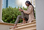 Music headphones, phone and black woman with coffee while sitting on city steps. Technology, tea break and happy female employee with caffeine and mobile for social media, streaming radio or podcast.