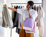 Shopping, discount and black woman talking on smartphone in fashion store with bags in luxury clothing boutique. Phone call, retail and happy customer looking at jacket for sale in designer shop.