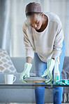 Black woman, cleaner and home spring cleaning of a professional maid holding dirty dishes. Working, housekeeper and focus of a female in a living room helping   with chores and housework in a lounge