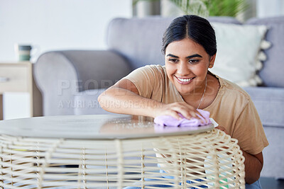 Buy stock photo Happy, woman and cleaning living room coffee table with household cloth and satisfied smile. Happiness, focus and concentration of young Indian girl polishing lounge furniture in house. 