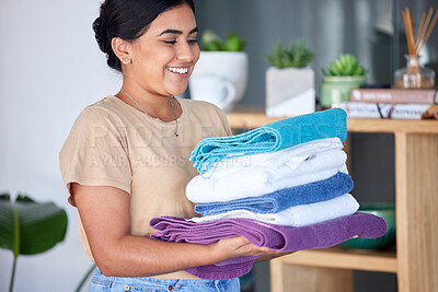 Buy stock photo Laundry, housework and towels with a woman cleaner working in a home for domestic hygiene as a maid. Cleaning, hospitality and fabric with a female housekeeper at work in a hotel room or house