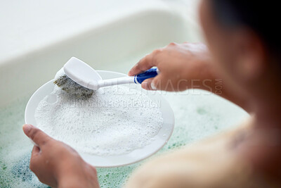 Buy stock photo Cleaning kitchen, soap water and hands of woman cleaner to clean plate with a brush for hygiene. Maid service for washing dishes to wash away bacteria, dirt or virus in house, home or apartment