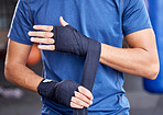 Fitness, boxing and tape with hands of man in gym for sport, workout and martial arts training. Exercise, strong and wellness with boxer and wrap bandage in mma class for fight, health or performance