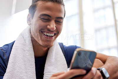 Buy stock photo Man relax, fitness and smartphone in gym, smile and rest after workout, training and typing for social media. Male, athlete and guy with cellphone, break and connection for chatting and with towel