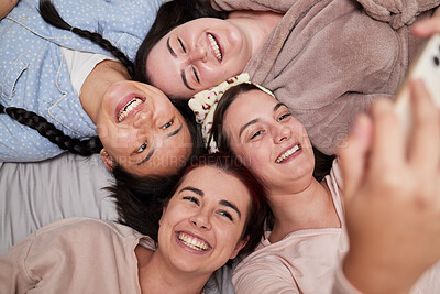 Buy stock photo Selfie, happy and friends lying in a circle while at a fun friendship sleepover at a house. Happiness, smile and women taking a picture for memories while relaxing, laughing and bonding together.