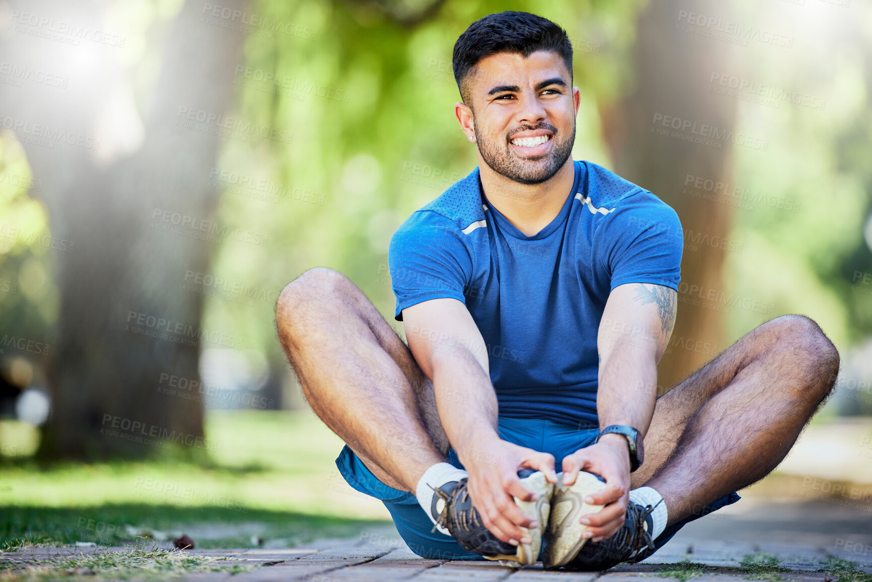 Buy stock photo Fitness, exercise and a man stretching outdoor at park for cardio workout, training and muscle warm up. Happy sports person or athlete in nature for a run and energy for health and wellness goals